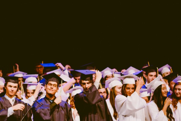 students in graduation cap and gowns - Photo by Caleb Woods on Unsplash