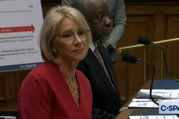 Education Secretary Betsy DeVos appears in a hearing looking sad